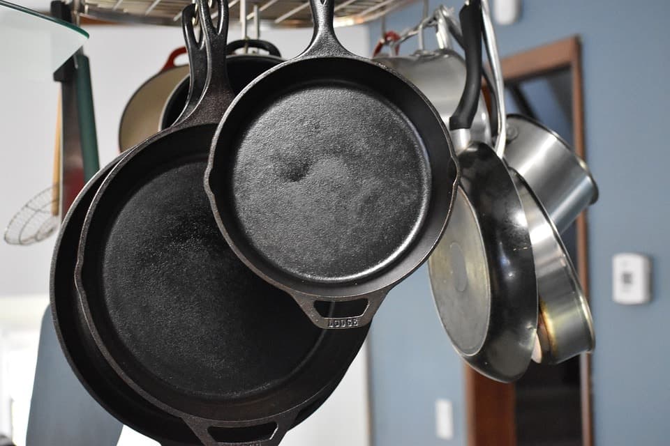 Cast iron skillets handing in a kitchen