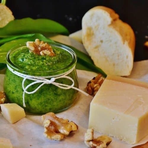 Pesto next to bread and cheese