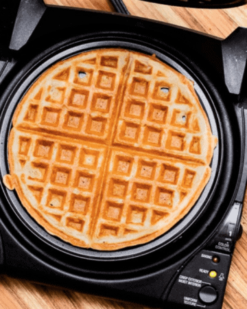 Waffle Maker with Blueberries and Syrup to the Side